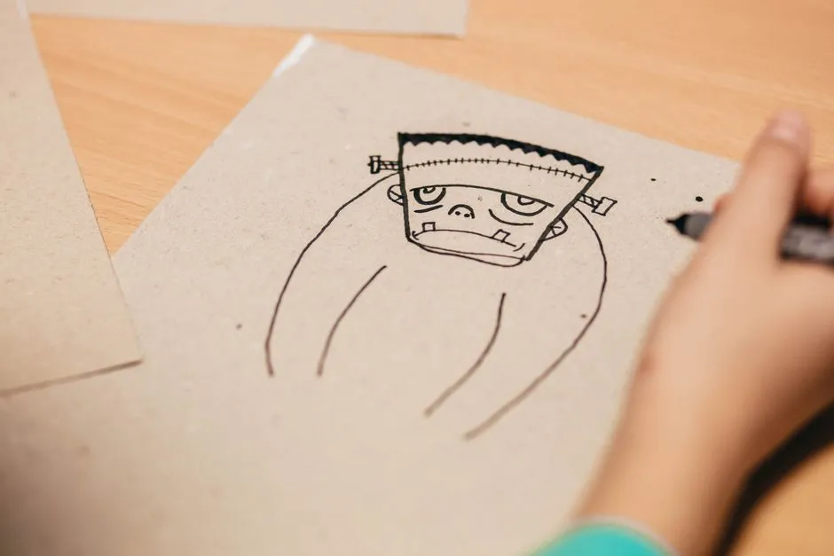 Half-finished cartoon koala on a tablet, coloured grey and brown, with the word koala printed under the drawing